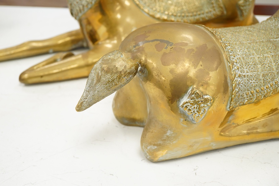 A pair of modern Chinese polished bronze 'Feng Shui' models of antlered recumbent deer with decorated bodies, height 66cm